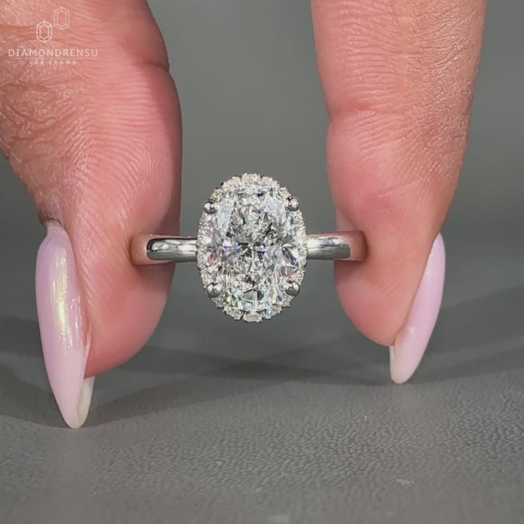 Oval Cut Diamond Ring with a stunning round cut diamond halo setting.
