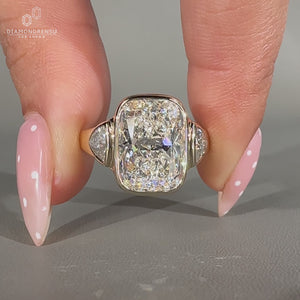 Cushion cut center diamond ring with trillion cut side diamonds.
