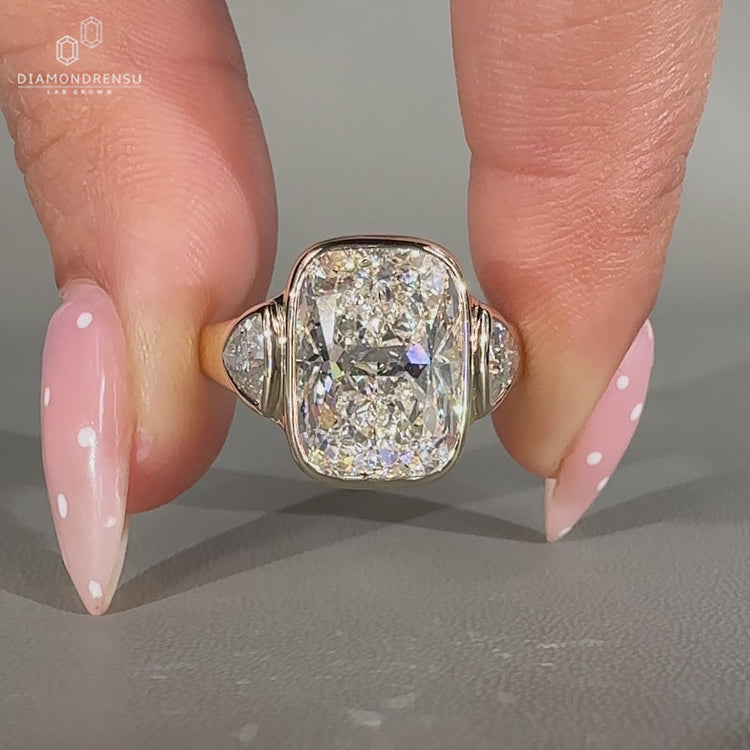 Cushion cut center diamond ring with trillion cut side diamonds.
