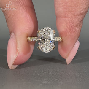 Yellow gold engagement ring with double claw prong for secure setting.
