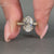 Yellow gold engagement ring with double claw prong for secure setting.
