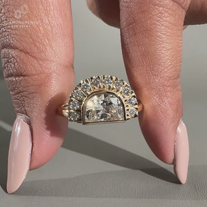 Round cut side stone with bezel setting ring.
