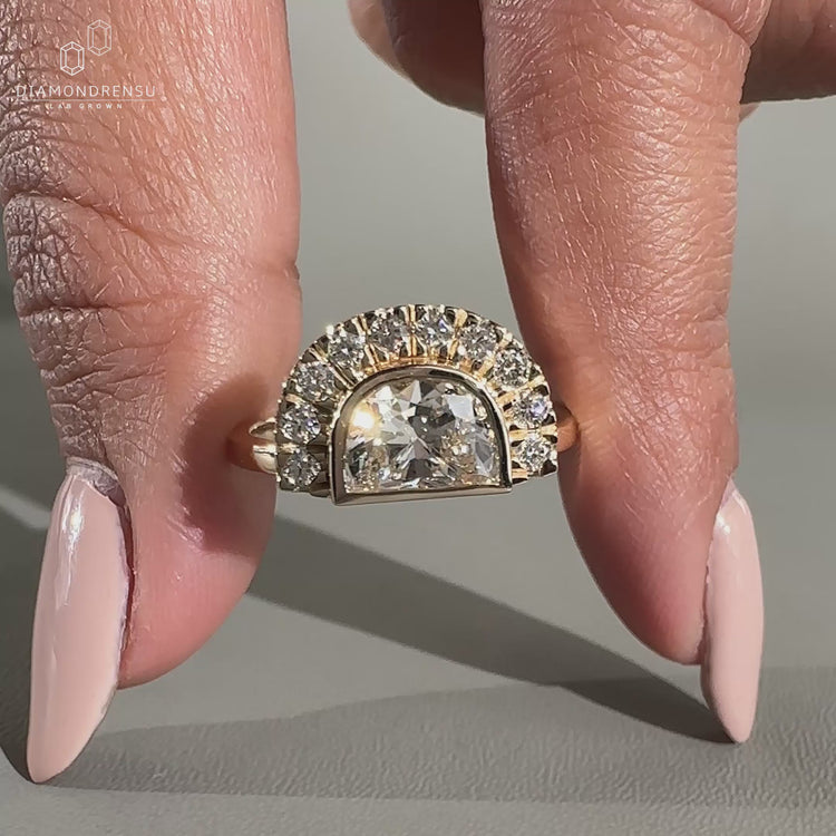 Round cut side stone with bezel setting ring.
