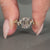 Emerald old european cut diamond ring with marquise and round side stones.
