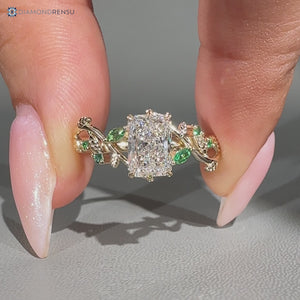 Radiant center stone engagement ring with marquise side stones.