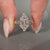 Handmade art deco diamond ring featuring a milgrain setting in yellow gold.
