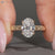 Oval center stone paired with vintage style and milgrain details.