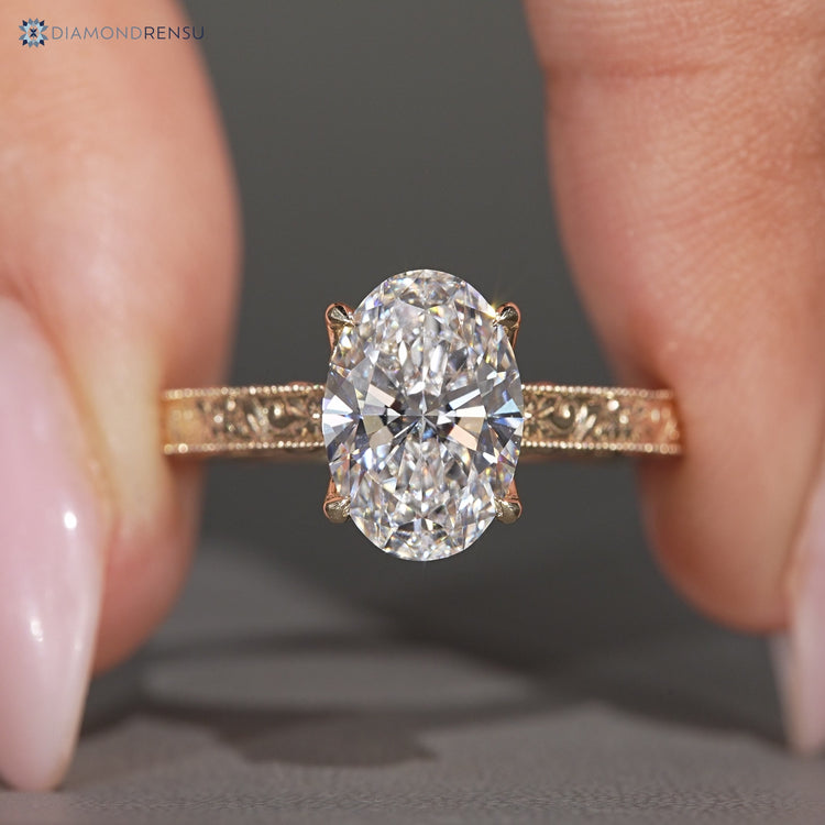 Oval center stone paired with vintage style and milgrain details.