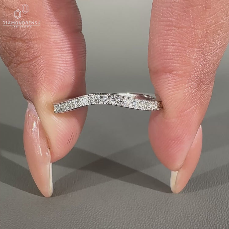 Round diamond wedding band in curved style.