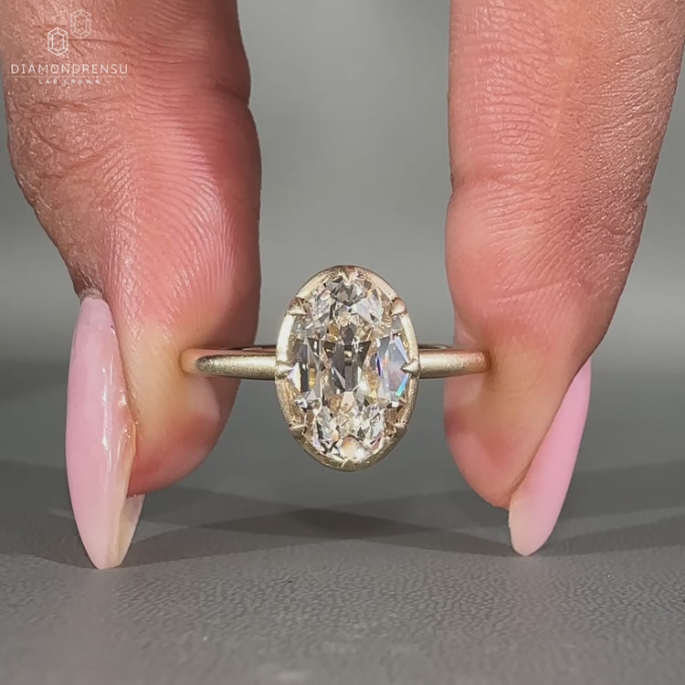 Oval old European cut ring with 8 claw prong design.
