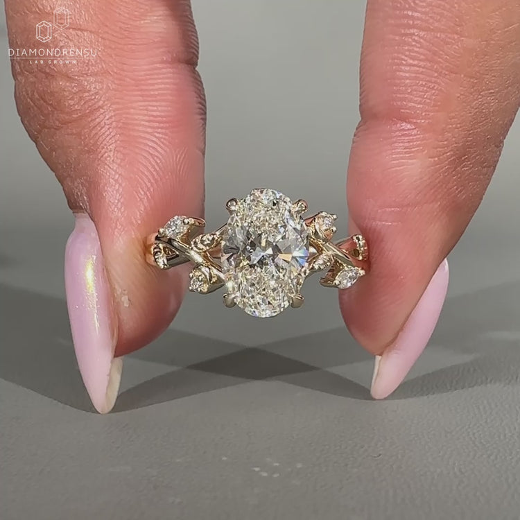 Center oval diamond cluster ring in yellow gold setting
