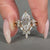 Kite side stones complement this marquise cut wedding ring.