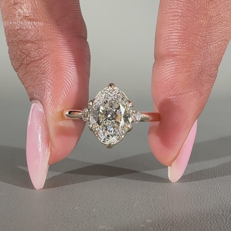 3 stone engagement ring with round diamond side stones.
