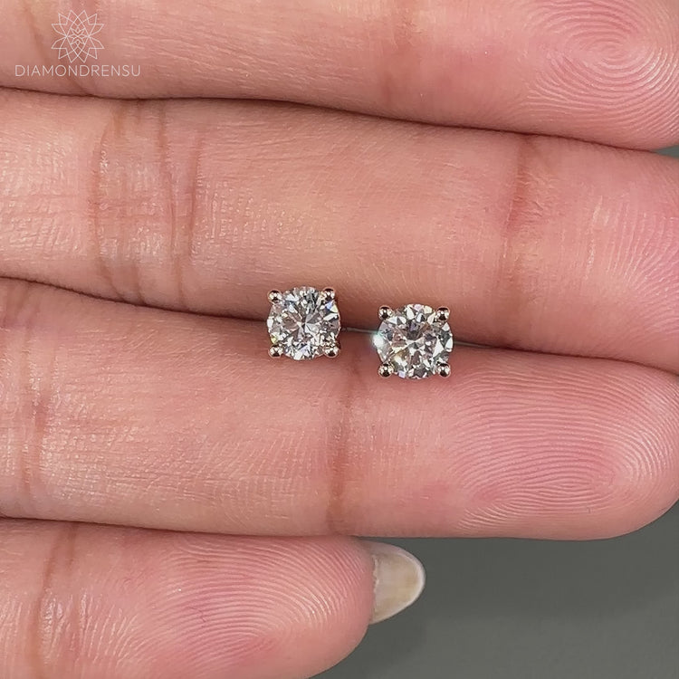 Stunning 0.70 TCW round stud earrings in a prong setting ring.
