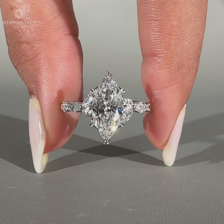 Nature inspired ring featuring marquise cut diamonds and shared prong setting.
