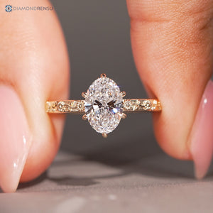 Oval nature inspired diamond ring with a six claw prong setting.