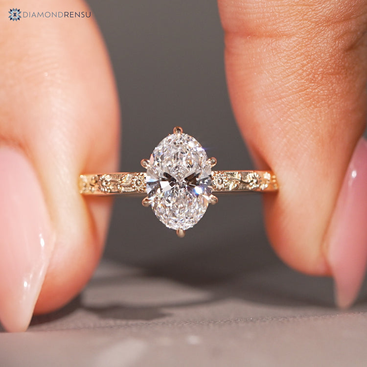 Oval nature inspired diamond ring with a six claw prong setting.