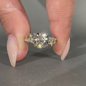 Round old european cut diamond ring with leaf design bypass pave setting.

