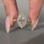 Marquise Diamond Ring With Round Cut Pave Band And Milgrain Details.