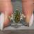 Green Dutch marquise diamond ring with round side stones.