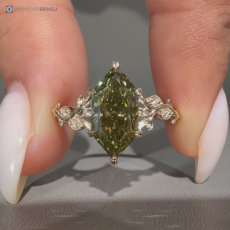 Green Dutch marquise diamond ring with round side stones.