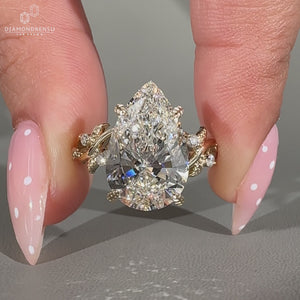 Pear shaped lab grown diamond ring with round cut side diamond.
