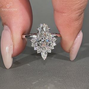 Lab grown coffin diamond ring with pear and round diamond accents.