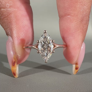 Marquise solitaire engagement ring in rose gold.
