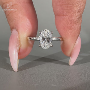 Handmade oval diamond ring with four claw prong setting.