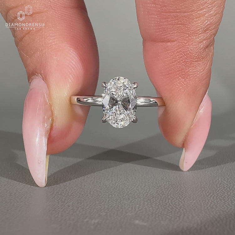 Handmade oval diamond ring with four claw prong setting.