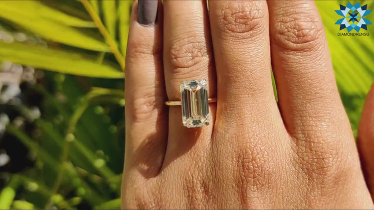 Solitaire setting with a single emerald cut moissanite stone.
