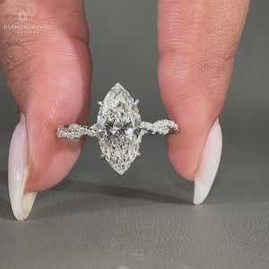 Round cut diamond ring worn on a hand with soft lighting.
