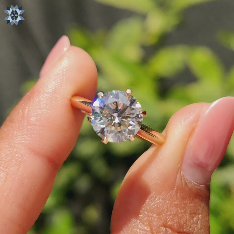 Round cut solitaire ring, featuring a sparkling moissanite stone in a classic six-prong setting.
