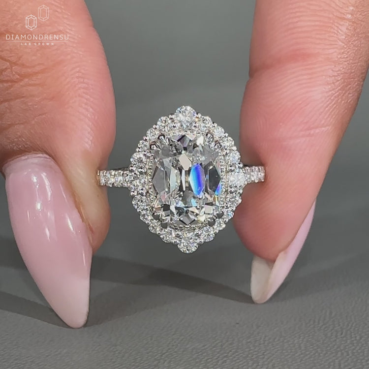 Vintage style diamond ring with cushion old mine center and cathedral band.

