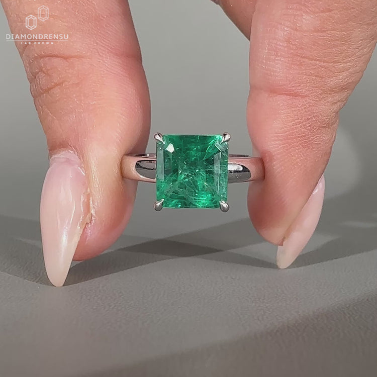 Asscher cut diamond ring with four claw prong setting.
