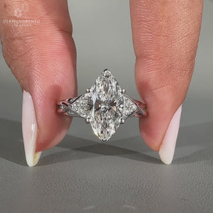 Seven stone diamond ring featuring marquise cut and round side stones.

