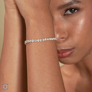 Round lab diamond tennis bracelet in yellow gold.
