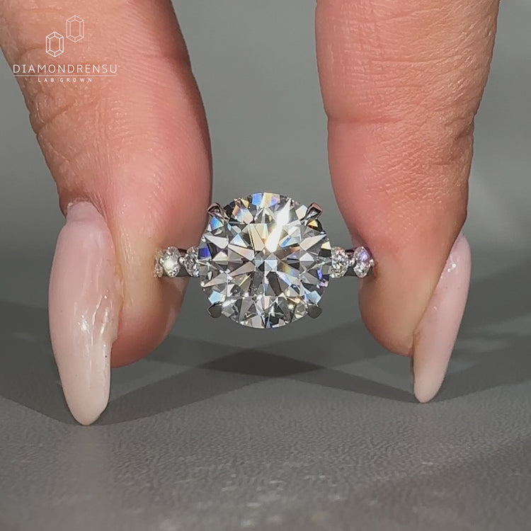 Round diamond engagement ring with hidden halo.
