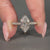 Cathedral setting ring featuring filigree details in yellow gold.
