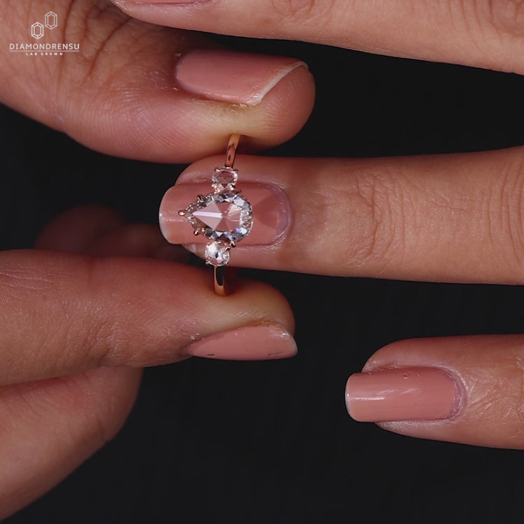 Rose Gold Engagement Ring with a pear diamond and Lab Grown Diamond.