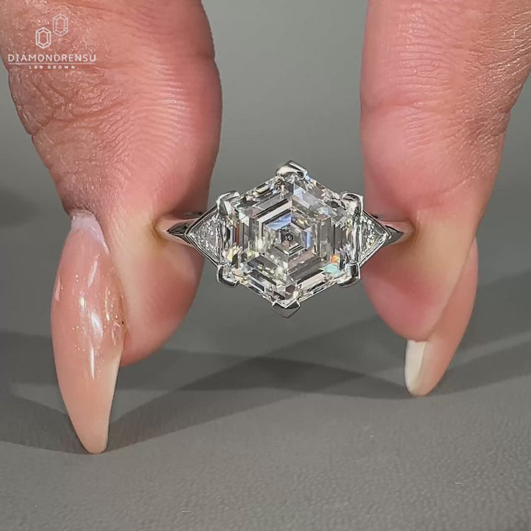 3 stone engagement ring featuring triangle side stones.
