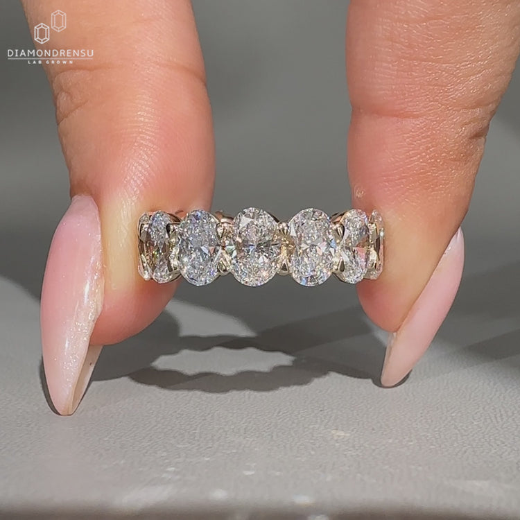 Lab grown oval diamond wedding band with shared prong setting.