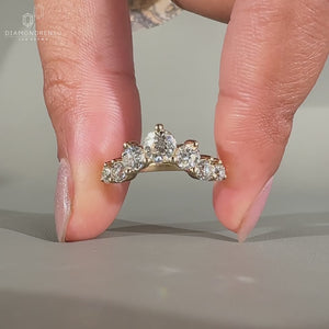 Round diamond band with shared prong setting in yellow gold.
