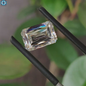 Moissanite loose stone sparkling next to criss cut moissanite.