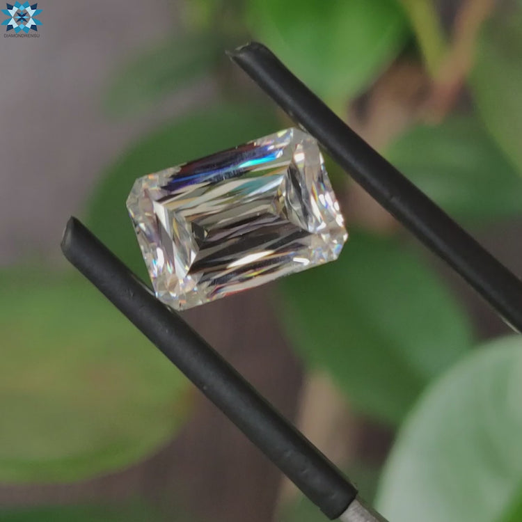 Moissanite loose stone sparkling next to criss cut moissanite.