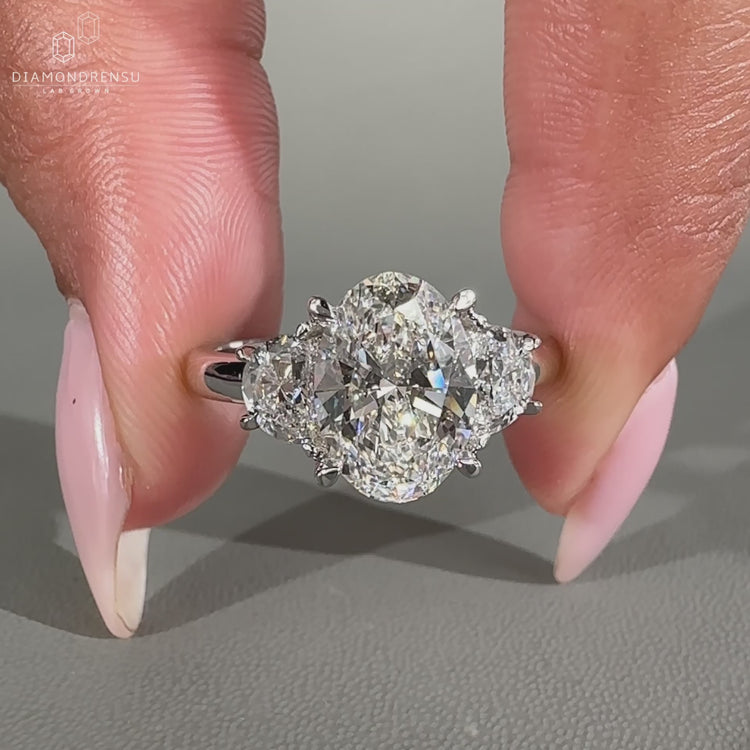 A three stone ring with oval and side diamonds
