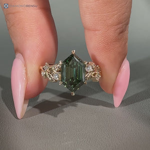 Green center stone defines this hexagon diamond ring with nature inspired style.