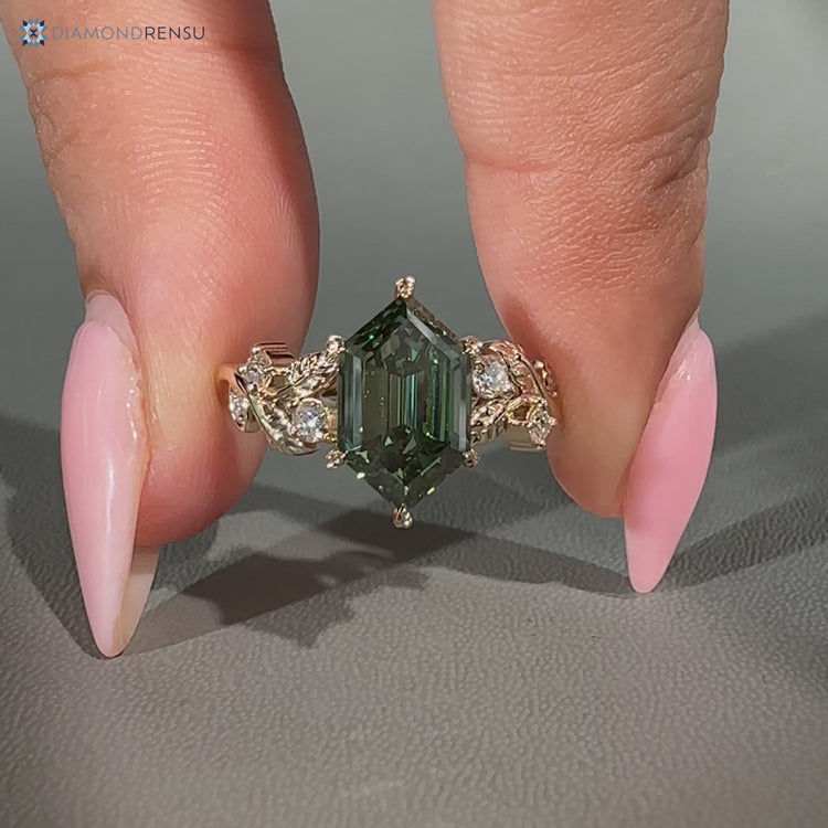 Green center stone defines this hexagon diamond ring with nature inspired style.