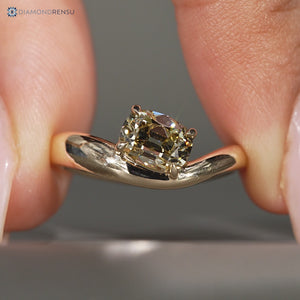 Light yellow cushion old mine cut ring with east to west setting.