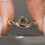 Light yellow cushion old mine cut ring with east to west setting.